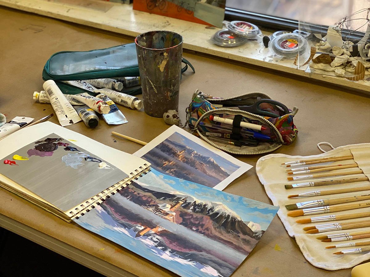 Creative workspace for adult art classes with painting materials and studio setup