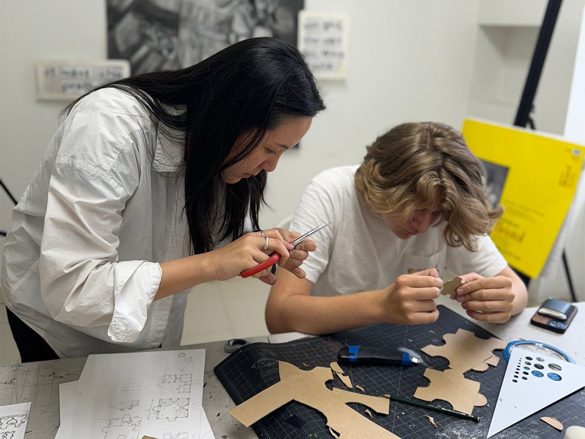 Art instructor guiding student in portfolio preparation and competition work at New York Art Studio NYC