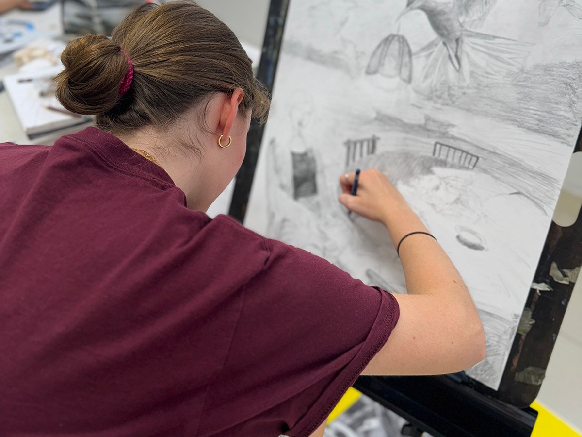 Art student practicing drawing as part of structured portfolio development program in NYC