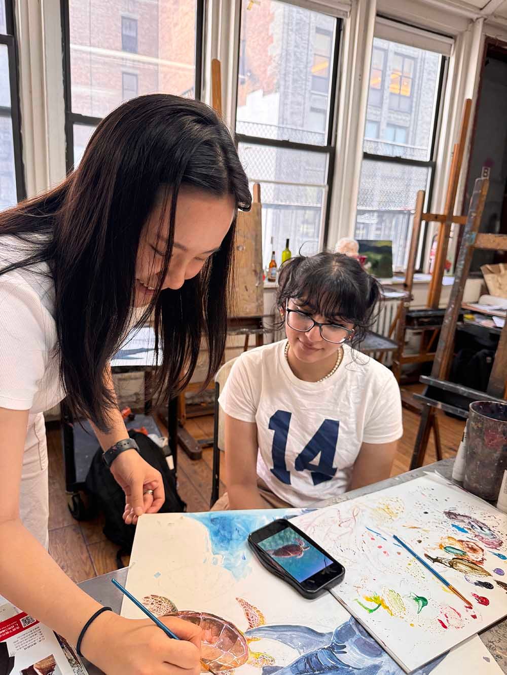 Art instructor guiding students during a studio class at New York Art Studio in New York City
