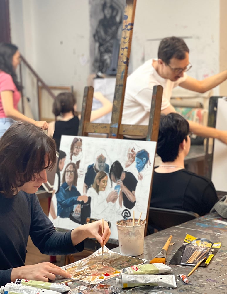 Students receiving one-on-one art instruction in a studio class at New York Art Studio in NYC