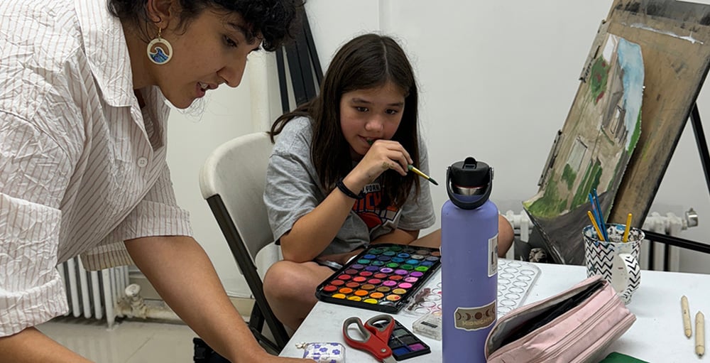 Instructor providing one on one guidance during private art lesson for portfolio development