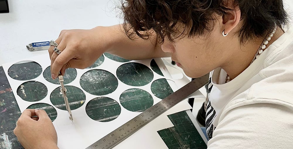 Student working on detailed portfolio project during private art class session
