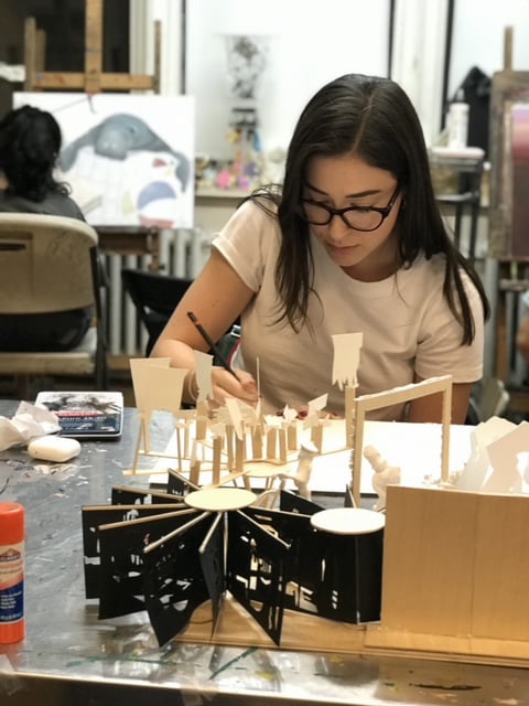 Student working on a detailed model project for art portfolio preparation at New York Art Studio