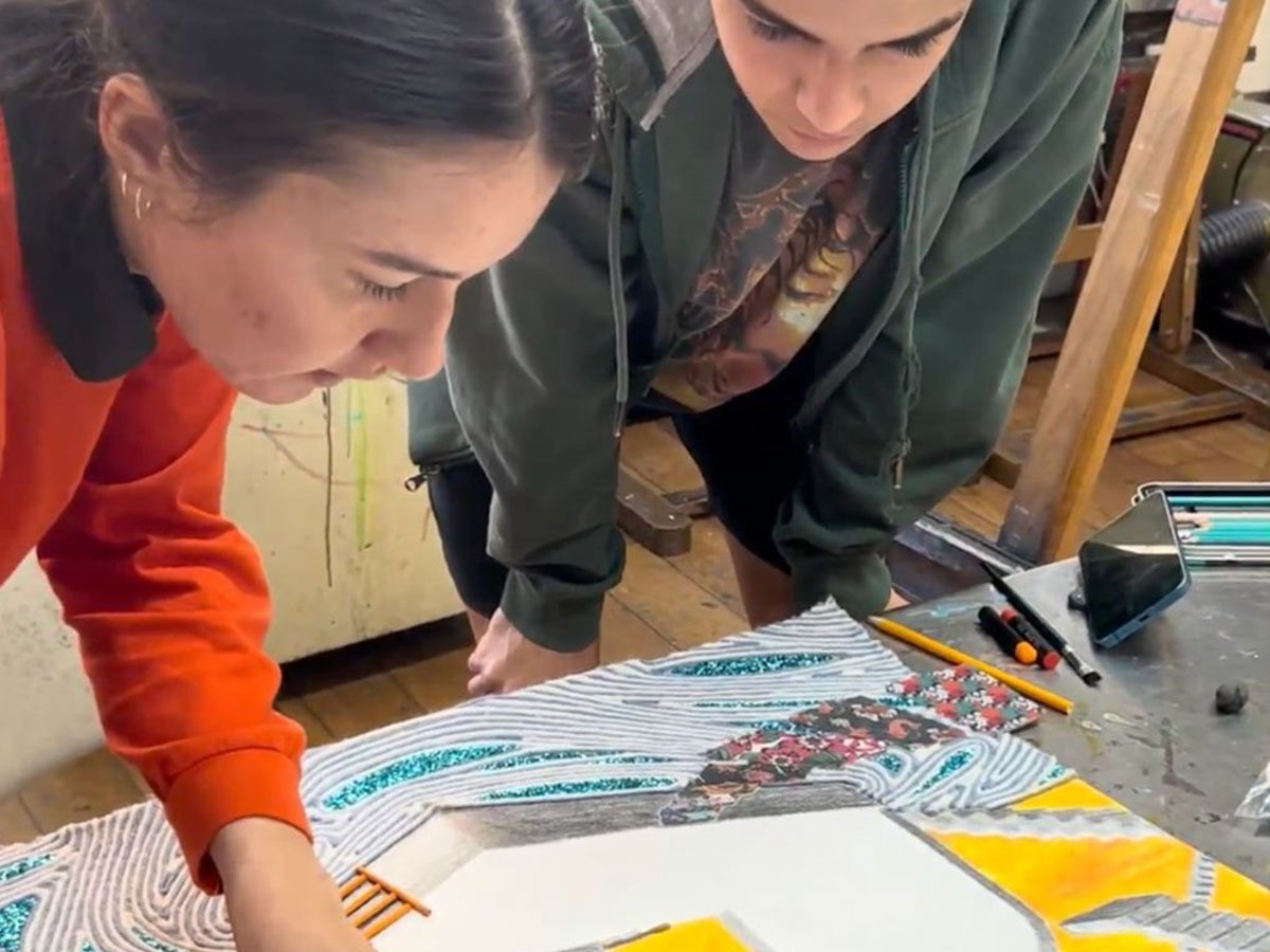 Teen students working on creative art projects including drawing and painting in studio