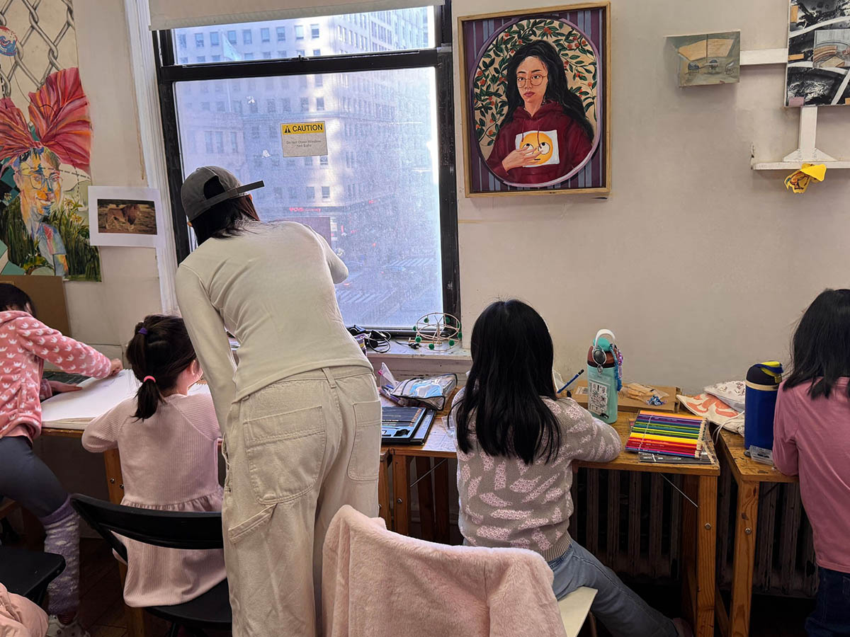 Children painting and exploring creativity during an art class session in NYC